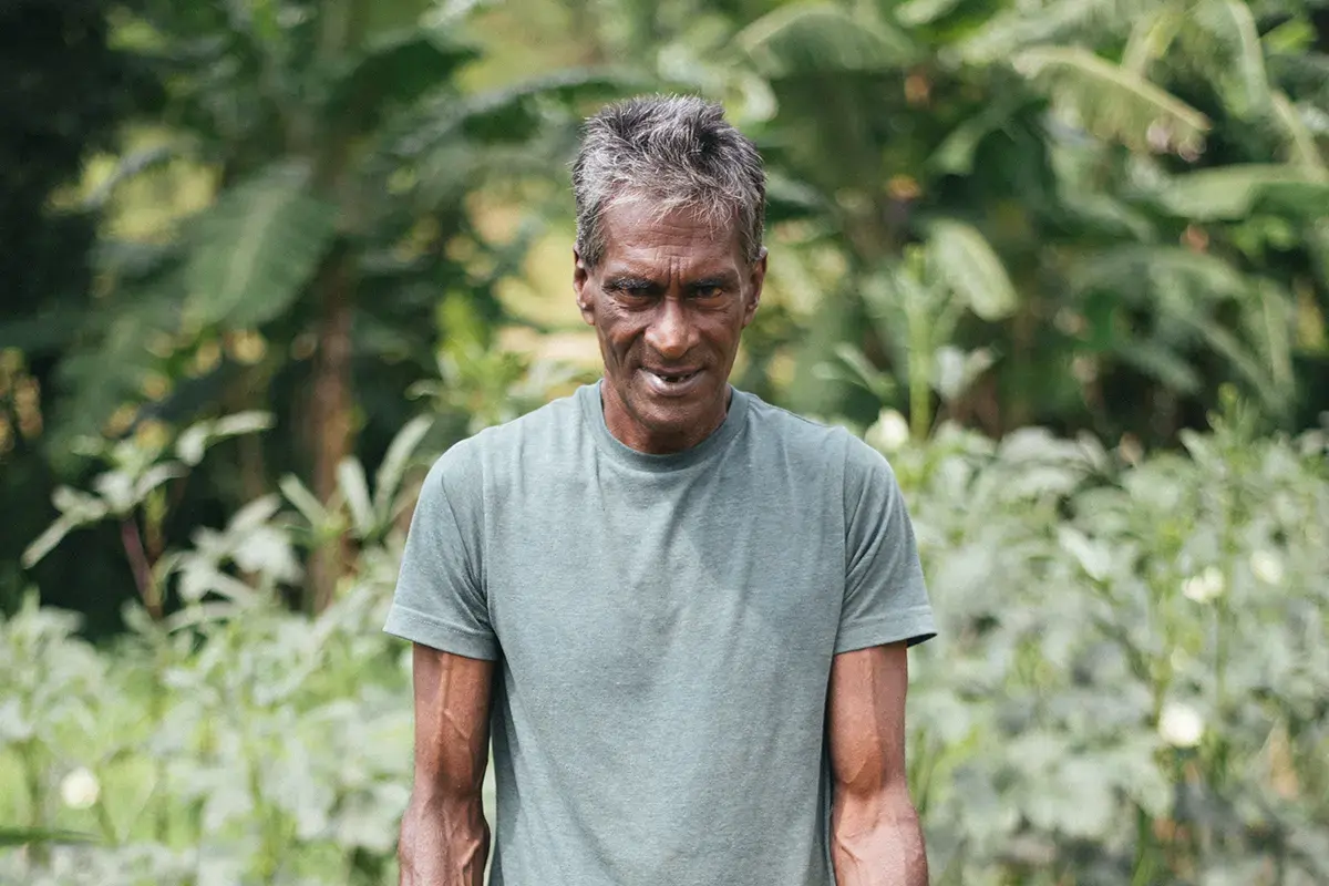 A gardener carrying a woven harvest basket
